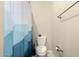 This bathroom has a toilet, towel rack, and shower with a blue and white shower curtain at 1849 E Chelsea Ln # 107, Gilbert, AZ 85295