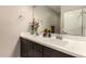 This bathroom has a double vanity with quartz counters and a large mirror at 1849 E Chelsea Ln # 107, Gilbert, AZ 85295