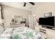 This bedroom has a ceiling fan, a dresser, and a TV at 1849 E Chelsea Ln # 107, Gilbert, AZ 85295
