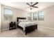 This bedroom has neutral carpeting, a ceiling fan, and three windows letting in natural light at 1849 E Chelsea Ln # 107, Gilbert, AZ 85295