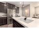 Modern kitchen island featuring a stainless steel sink, quartz countertop, and stylish faucet at 1849 E Chelsea Ln # 107, Gilbert, AZ 85295