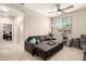 Cozy living room featuring a gray sectional, ceiling fan, and plenty of natural light at 1849 E Chelsea Ln # 107, Gilbert, AZ 85295