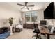 This is an office with a ceiling fan, two windows, and both work and relaxation spaces at 1849 E Chelsea Ln # 107, Gilbert, AZ 85295