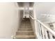 Carpeted stairway with white banister, ascending to the upper level of the home at 1849 E Chelsea Ln # 107, Gilbert, AZ 85295