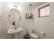 Cozy powder room with a pedestal sink, modern fixtures, and stylish decor at 1851 E Ellis St, Phoenix, AZ 85042