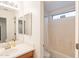 Bathroom with vanity, mirror, and tub/shower combination with white tile at 1851 E Ellis St, Phoenix, AZ 85042
