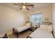 Cozy bedroom with twin beds, ceiling fan and scenic window view at 1851 E Ellis St, Phoenix, AZ 85042