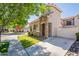 Charming two-story home featuring a stone-accented facade, lush lawn, and inviting curb appeal at 1851 E Ellis St, Phoenix, AZ 85042