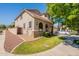 Home exterior featuring mature landscaping, a tiled roof, and manicured lawn at 1851 E Ellis St, Phoenix, AZ 85042