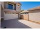 Exterior view of a home featuring a two-car garage, upper balcony, and desert landscaping at 1851 E Ellis St, Phoenix, AZ 85042