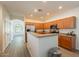 Spacious kitchen with wooden cabinets, stainless steel appliances, and a breakfast bar at 1851 E Ellis St, Phoenix, AZ 85042