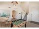 Open-concept living area with staircase, foosball table, and trendy furnishings in a bright space at 1851 E Ellis St, Phoenix, AZ 85042