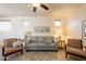 This comfortable living room features neutral tones, ceiling fan, tasteful decor, and modern flooring at 1851 E Ellis St, Phoenix, AZ 85042