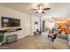 Open-concept living area featuring modern furnishings, wood floors, and a ceiling fan at 1851 E Ellis St, Phoenix, AZ 85042