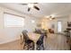 Open floor plan with a view of dining area, living room, and kitchen with ceiling fans and neutral decor at 1851 E Ellis St, Phoenix, AZ 85042
