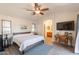 Spacious main bedroom with wood bed frame, ensuite bathroom, and a ceiling fan at 1851 E Ellis St, Phoenix, AZ 85042