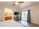 Main bedroom featuring a private balcony, ensuite bathroom, and a ceiling fan at 1851 E Ellis St, Phoenix, AZ 85042