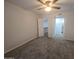 Bright bedroom with ceiling fan and neutral carpeted floor features access to ensuite bathroom and walk-in closet at 200 E Southern Ave # 363, Tempe, AZ 85282