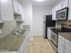 Efficient kitchen features stainless appliances, granite countertops, and white cabinets at 200 E Southern Ave # 363, Tempe, AZ 85282