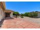 Backyard view showing covered patio, shade trees, and low-maintenance gravel landscaping at 2005 Leisure World --, Mesa, AZ 85206
