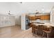 Bright kitchen featuring wood cabinets, stainless steel appliances, a breakfast bar, and durable laminate flooring at 2005 Leisure World --, Mesa, AZ 85206