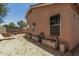 Side view of a large backyard with exterior block-textured walls, sparse greenery, and a brick-floored section at 2025 S 83Rd Dr, Tolleson, AZ 85353