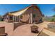 Spacious backyard featuring brick flooring, fire pit, exterior walls, and a light shade-sail cover at 2025 S 83Rd Dr, Tolleson, AZ 85353