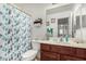 Bathroom featuring a shower, vanity, and decorated mirror at 2025 S 83Rd Dr, Tolleson, AZ 85353