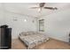 Cozy bedroom featuring neutral tiling, a ceiling fan, and natural light at 2025 S 83Rd Dr, Tolleson, AZ 85353