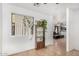 Inviting entryway featuring neutral walls, decorative plants, and tiled flooring extending to a comfortable living space at 2025 S 83Rd Dr, Tolleson, AZ 85353