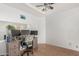 Functional home office space with a large desk, ample lighting, and neutral tiling at 2025 S 83Rd Dr, Tolleson, AZ 85353