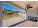Covered patio boasts brick pavers, a ceiling fan, and a view of the landscaped backyard at 20644 W Mariposa St, Buckeye, AZ 85396