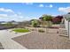 Manicured backyard with a putting green, desert plants, and a stone patio at 20644 W Mariposa St, Buckeye, AZ 85396
