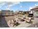 Backyard with a fire pit, grill, desert landscaping, pavers, and a covered patio for outdoor entertaining at 20644 W Mariposa St, Buckeye, AZ 85396