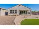 Exterior view of backyard with manicured artificial turf and covered patio area at 20644 W Mariposa St, Buckeye, AZ 85396