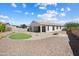 Aerial view of the backyard featuring a stone patio, putting green, and covered patio at 20644 W Mariposa St, Buckeye, AZ 85396
