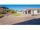 Spacious backyard with covered patio, synthetic grass area, and easy to care for desert landscaping at 20644 W Mariposa St, Buckeye, AZ 85396