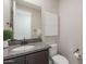 Stylish powder room features granite counters, dark wood cabinets, and modern fixtures at 20644 W Mariposa St, Buckeye, AZ 85396
