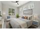 Staged bedroom with neutral walls, tile flooring, white furniture and stylish bedding and decor at 20644 W Mariposa St, Buckeye, AZ 85396