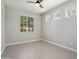 Bright bedroom with neutral tile flooring, a ceiling fan, and multiple windows with natural light at 20644 W Mariposa St, Buckeye, AZ 85396
