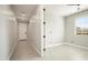 Bright, empty bedroom featuring neutral tile floors, a window, and a hall closet at 20644 W Mariposa St, Buckeye, AZ 85396