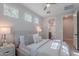 Well-lit bedroom boasts three windows, plush bedding, and convenient ensuite bathroom at 20644 W Mariposa St, Buckeye, AZ 85396