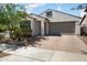 Single-Gathering home with a welcoming facade, a brick driveway, and well-maintained landscaping at 20644 W Mariposa St, Buckeye, AZ 85396