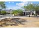 Well-maintained front yard with lush trees, desert landscaping, and mountain views at 20644 W Mariposa St, Buckeye, AZ 85396