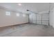 Clean garage with a newly installed door, bright lights, and multiple windows providing ample natural light at 20644 W Mariposa St, Buckeye, AZ 85396