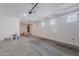 Spacious garage with ample storage space, bright lighting, and clean concrete flooring for easy maintenance at 20644 W Mariposa St, Buckeye, AZ 85396
