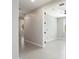 Neutral walls and flooring in hallway leading to an open doorway into a bright, naturally lit space at 20644 W Mariposa St, Buckeye, AZ 85396