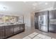 Modern kitchen featuring gray cabinets, granite countertops, and stainless steel appliances at 20644 W Mariposa St, Buckeye, AZ 85396