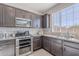 Modern kitchen featuring stainless steel appliances, granite countertops, and dark wood cabinetry at 20644 W Mariposa St, Buckeye, AZ 85396