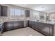 Well-lit kitchen featuring granite countertops, stainless steel appliances, and dark brown cabinets at 20644 W Mariposa St, Buckeye, AZ 85396